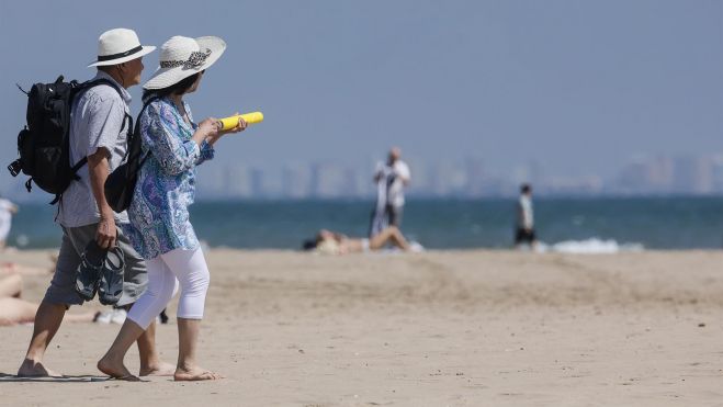 Dos personas disfrutan del calor en la Comunitat Valenciana paseando por la playa de la Malvarrosa, en València. - Rober Solsona - Europa Press - Archivo