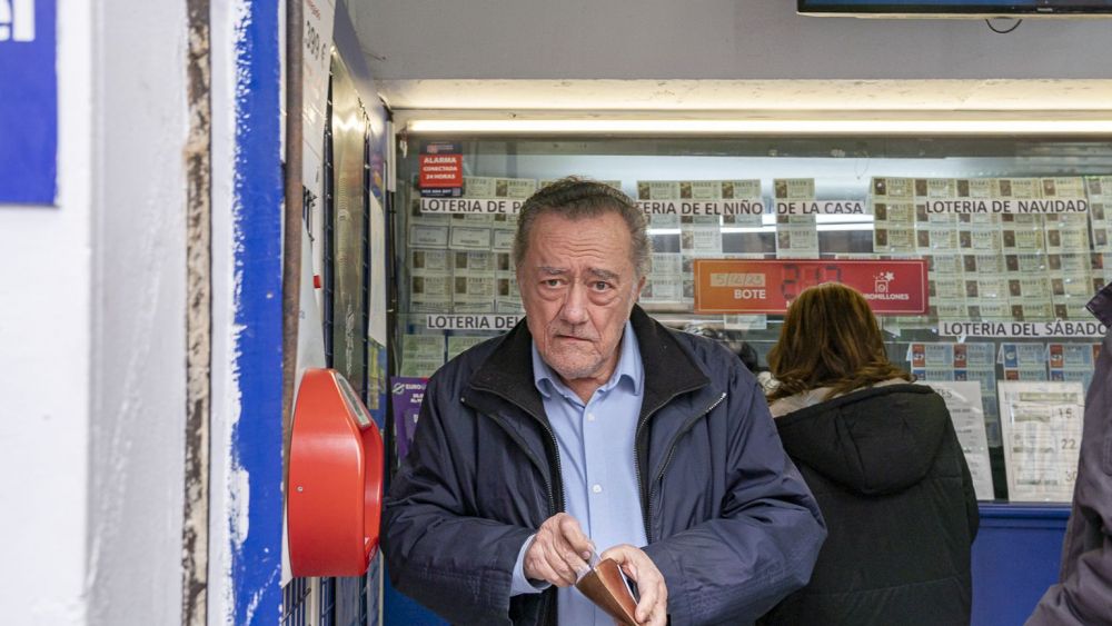 Gente comprando lotería de Navidad en una administración de València. Foto Xisco Navarro